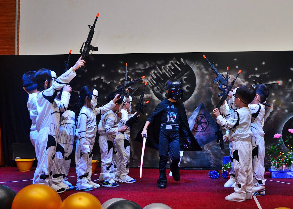 Children performing together on stage at a D Loving concert