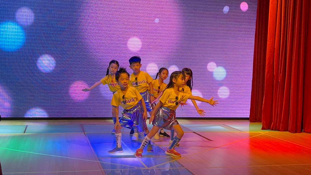 Children presenting a colourful concert performance