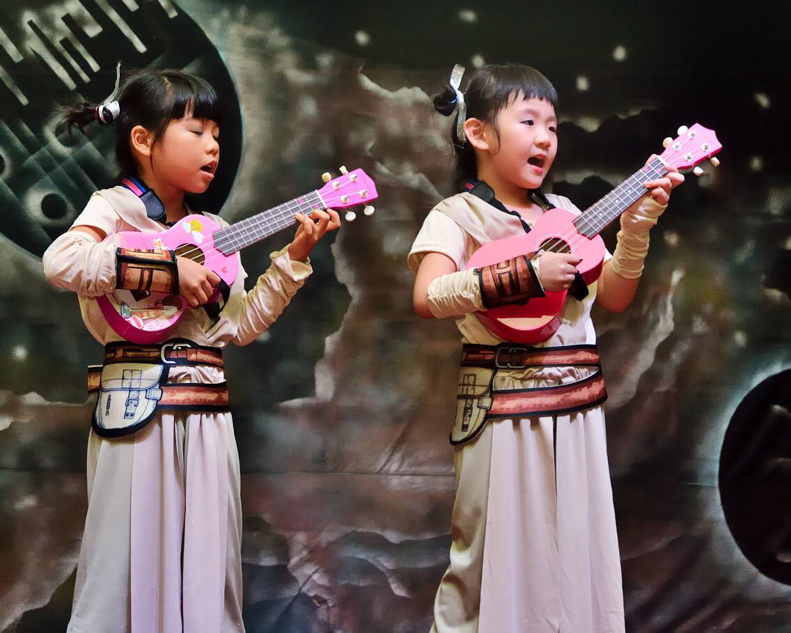 Young performers celebrating together during a concert