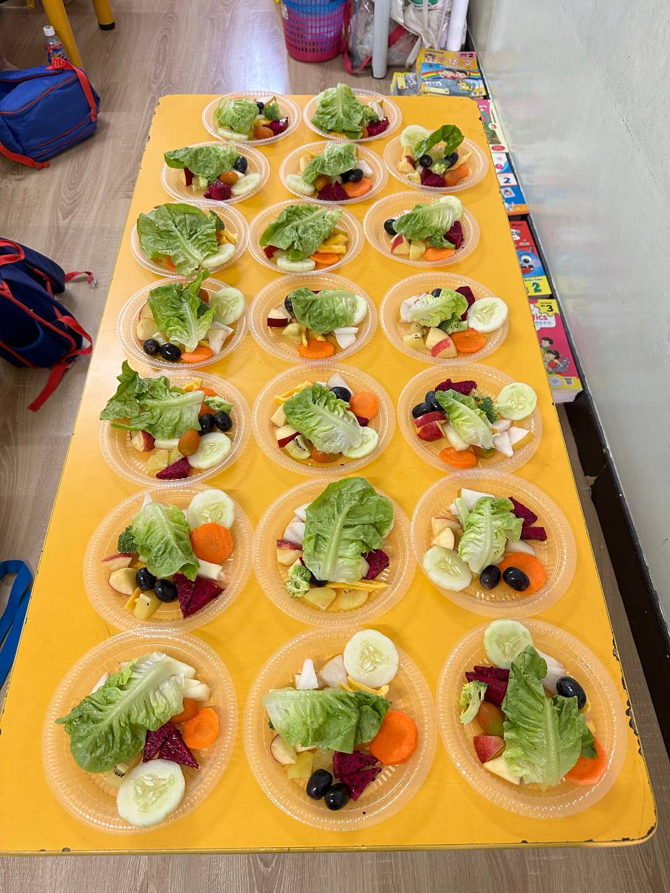 Children exploring colourful fresh fruit and vegetables during a learning activity
