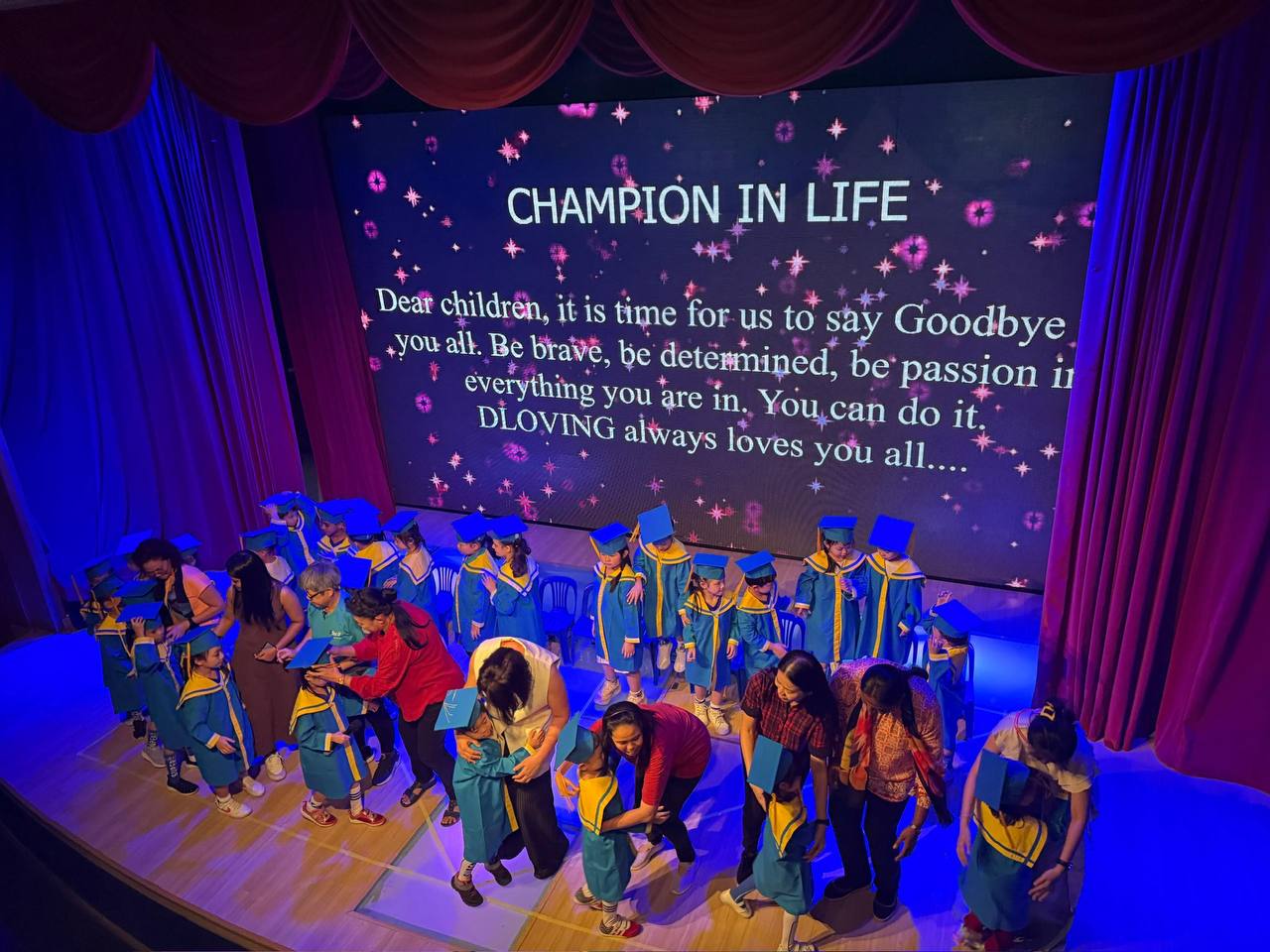 Children and families celebrating a D Loving graduation