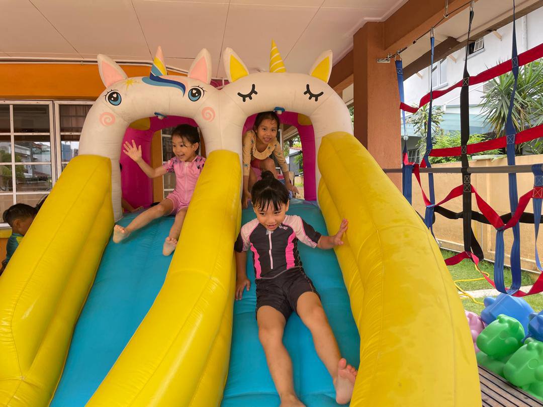 Children enjoying active play on an inflatable slide