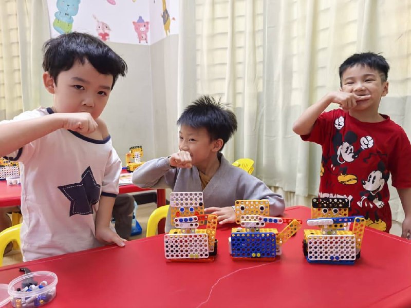 Children learning in a robotics class by making a robot brush teeth