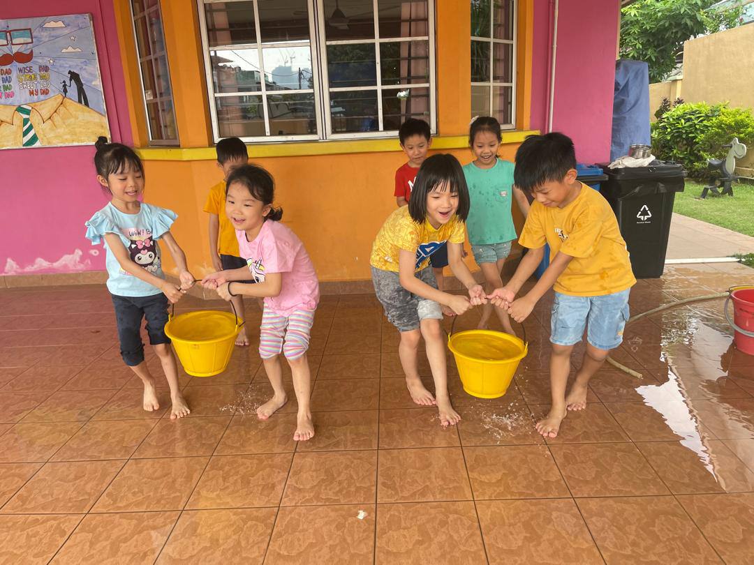 Children working together during a water activity