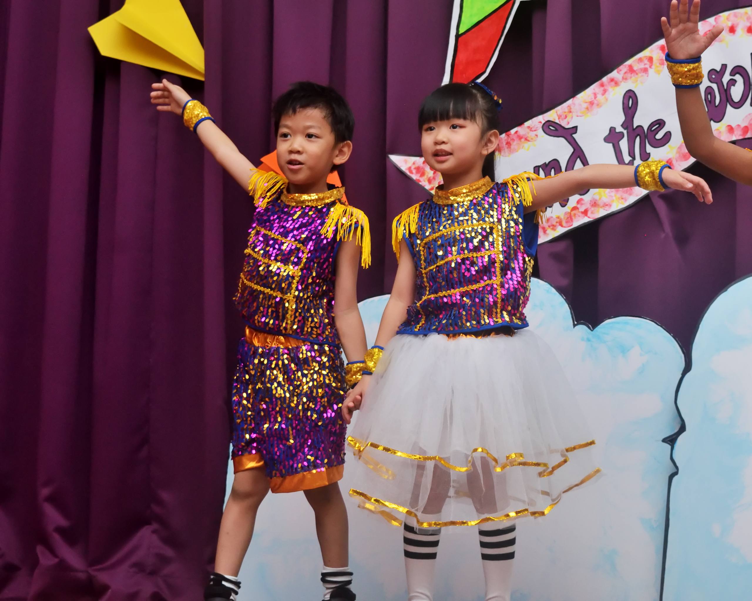 Two children performing a dance together at a Dloving yearly concert