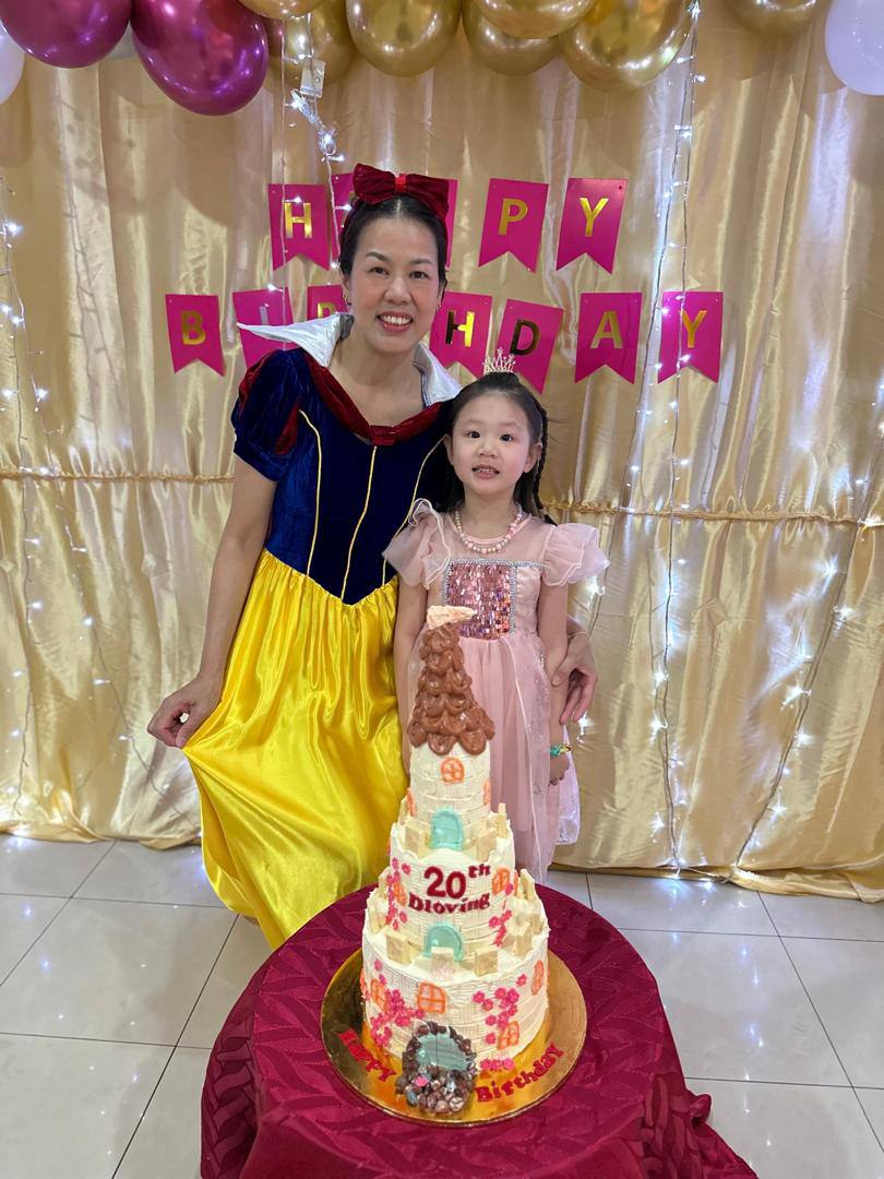 Yvonne celebrating D Loving's twentieth anniversary with a child